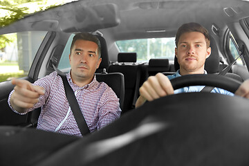 Image showing car driving school instructor teaching male driver