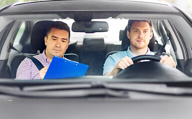 Image showing car driving school instructor and young driver