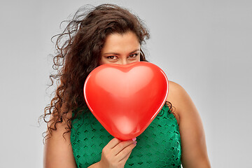 Image showing playful woman holding red heart shaped balloon