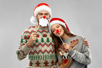 Image showing couple with christmas party props in ugly sweaters