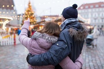 Image showing happy senior couple hugging at christmas market