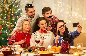 Image showing friends taking selfie at christmas dinner