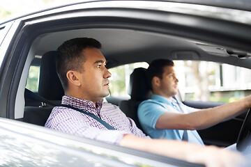 Image showing car driving school instructor and male driver