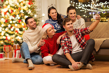 Image showing friends celebrating christmas and taking selfie