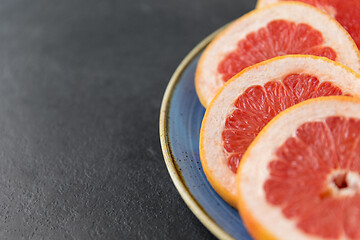 Image showing close up of fresh juicy grapefruits on plate