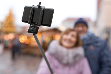 Image showing senior couple taking selfie at christmas market