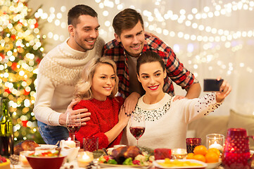 Image showing friends taking selfie at christmas dinner