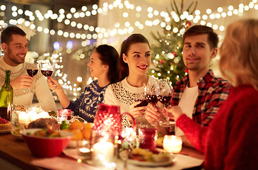 Image showing happy friends celebrating christmas at home feast