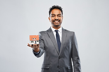 Image showing man realtor with house model and folder