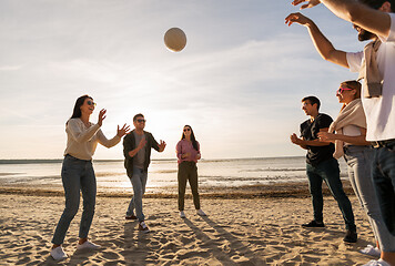 Image showing friends playing volleyball on beach in summer