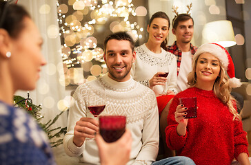 Image showing friends celebrating christmas and drinking wine