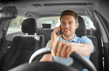 Image showing man driving car and calling on smartphone