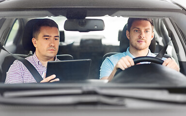 Image showing car driving school instructor and young driver