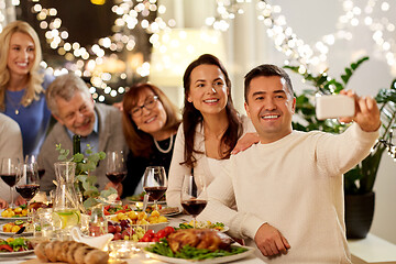 Image showing family having dinner party and taking selfie