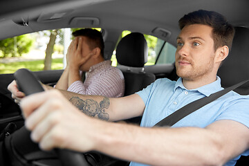 Image showing car driving school instructor and male driver