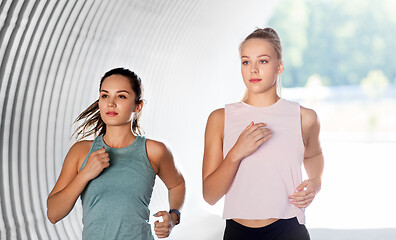 Image showing young women or female friends running outdoors