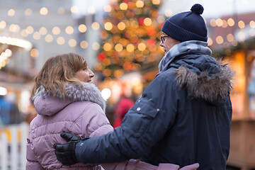 Image showing happy senior couple hugging at christmas market