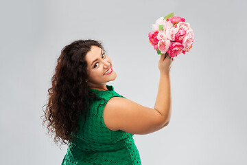 Image showing happy woman in green dress with flower bunch