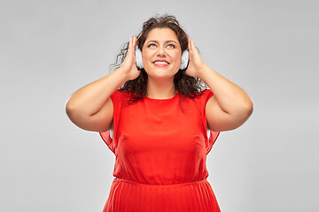 Image showing happy woman in headphones listening to music