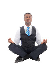 Image showing Handsome African man sitting doing yoga