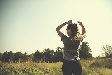 Image showing woman jogging along a country road