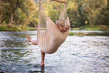 Image showing blonde woman resting on hammock