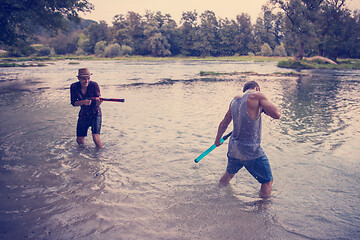 Image showing young men having fun with water guns