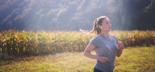 Image showing woman jogging along a country road