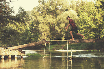 Image showing man jumping into the river