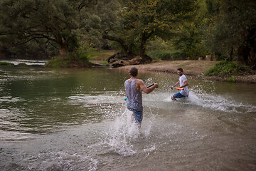 Image showing young men having fun with water guns