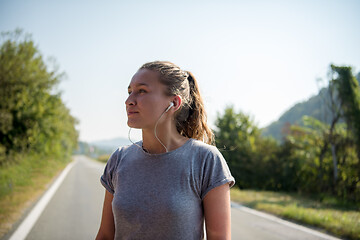 Image showing woman jogging along a country road