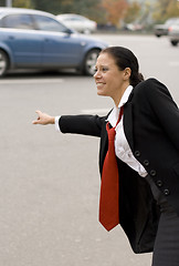 Image showing hitchhiking businesswoman 