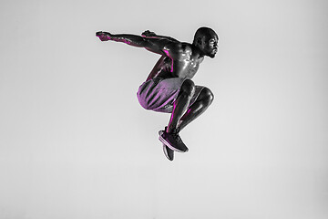 Image showing Young african-american bodybuilder training over grey background