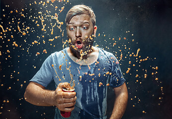 Image showing Man drinking a cola and enjoying the spray.