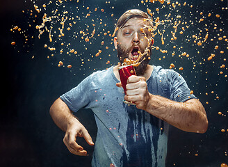 Image showing Man drinking a cola and enjoying the spray.