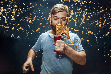 Image showing Man drinking a cola and enjoying the spray.