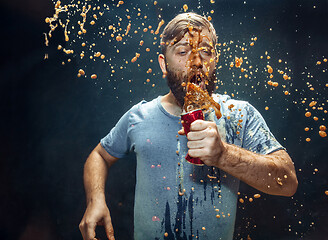 Image showing Man drinking a cola and enjoying the spray.