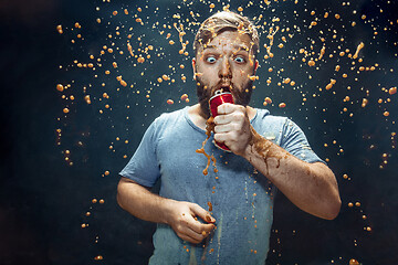 Image showing Man drinking a cola and enjoying the spray.