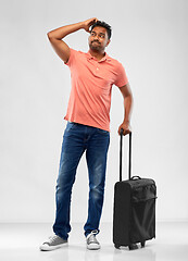 Image showing puzzled indian man with travel bag shrugging