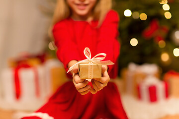 Image showing close up of girl with christmas gift at home