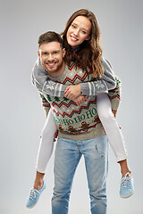 Image showing happy couple at christmas ugly sweater party