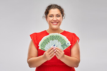Image showing happy woman holding hundreds of money banknotes