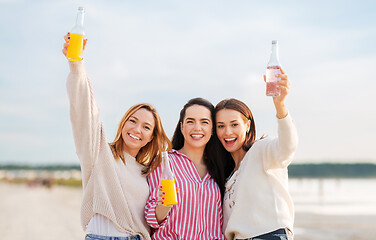 Image showing young women toasting non alcoholic drinks on beach