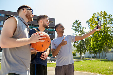 Image showing happy men taking selfie on basketball playground