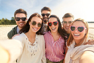 Image showing happy friends taking selfie on summer beach