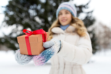 Image showing close up of woman with christmas gift in winter