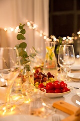 Image showing table served with plates, wine glasses and food