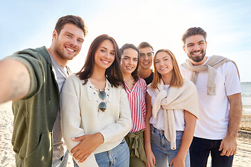 Image showing happy friends taking selfie on summer beach