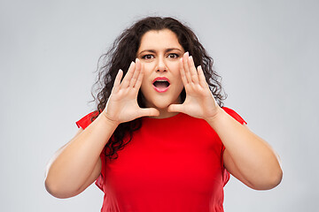 Image showing worried woman in red dress calling