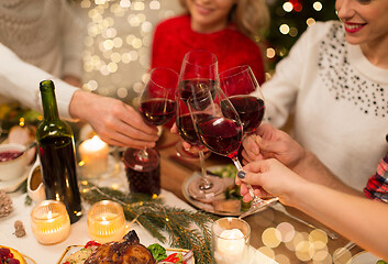 Image showing close up of friends with wine celebrate christmas